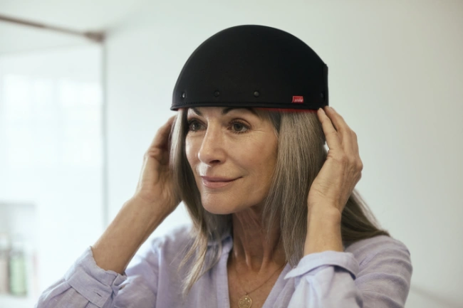 REVIAN Red Hair Growth System - Woman wearing cap Woman wearing the REVIAN Red Hair Growth System